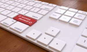 computer keyboard with red button that says access denied