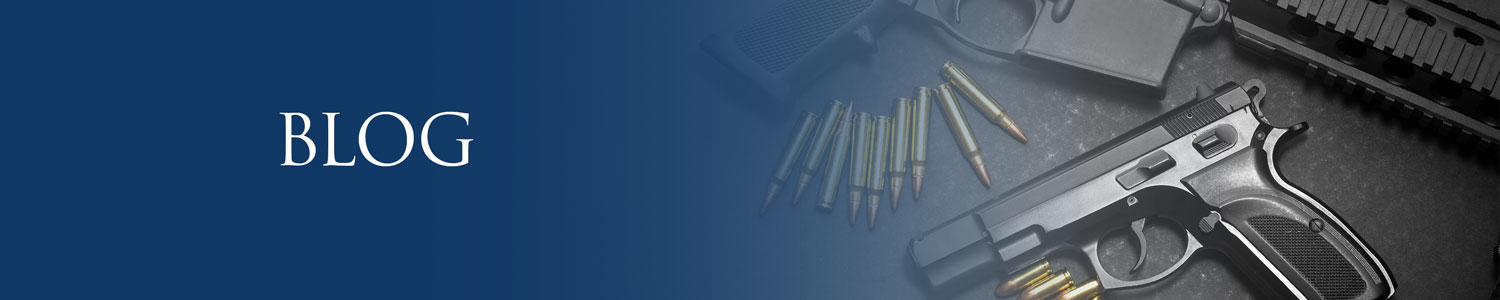 Hand gun, automatic gun and bullets laid out on a table, possession of a firearm by a felon blog