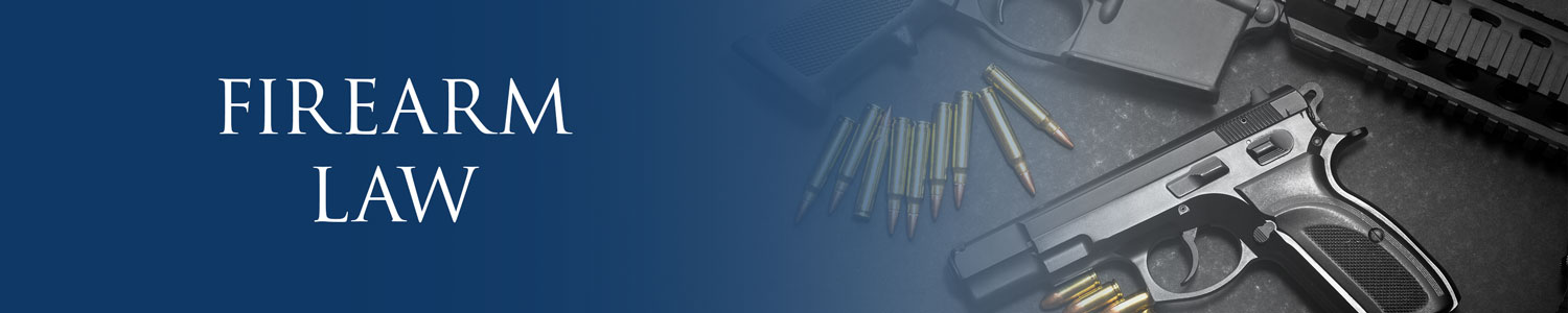 Hand gun, automatic gun and bullets laid out on a table - Firearm Law